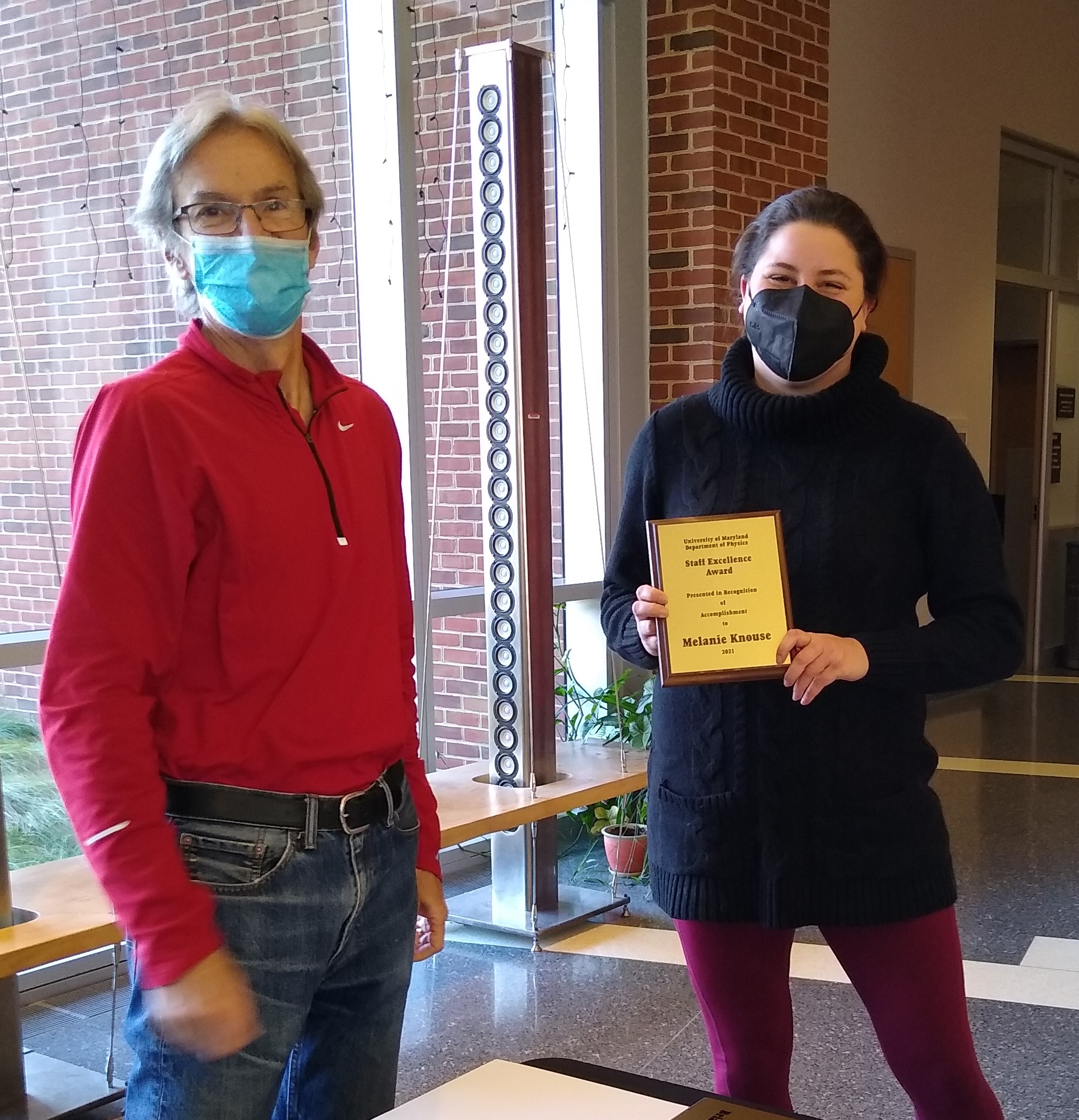 Steve Rolston presents Melanie Cline with a Staff Excellence Award in 2021.