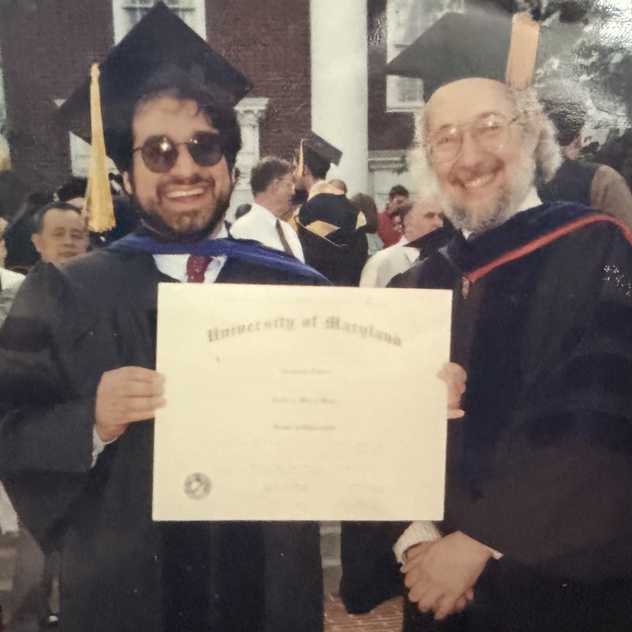 Jeff Saul and Joe Redish in cap and gown at Saul's PhD ceremony.